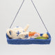 Handcrafted felt ornament of an embroidered tea tray topped with finger sandwiches, pastries, and a small bouquet of flowers. Made from merino-blend wool with soft textures and fine stitching, this ornament includes a hanging string and measures approximately 1.25 inches high and 3.75 inches wide. A charming nod to English tea parties and cozy mornings.