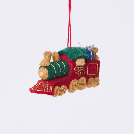 Craftspring’s Toy Train Ornament — felt red and green train with gold embroidery, intricately detailed with a team engine carrying presents and a teddy bear — heirloom-quality Christmas ornament, perfect for holiday gifting, ethically crafted by artisans using sustainable wool.