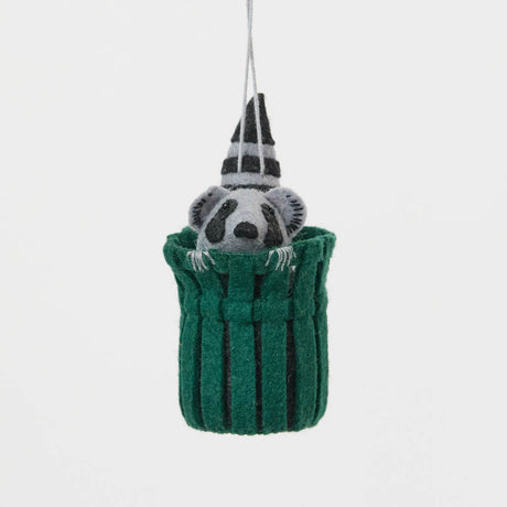 Every city has its unofficial mascot, and New York's just might be the mischievous raccoon. Meet our Trash Raccoon Ornament, peeking curiously from inside a classic green city trash can with the sweetest little face you've ever seen. Don't worry—this tiny trash panda is all charm and absolutely no trouble.
