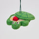 Handmade felt Turtle Sandbox ornament from Craftspring, with the turtle shell cover slightly ajar to reveal beaded sand, a bucket, mini shovel, and starfish inside—heirloom-quality summer decor, ethically crafted by artisans in India using sustainable wool.