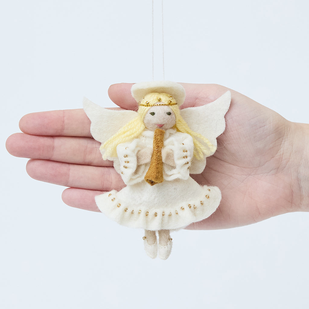 Craftspring’s Vintage-Style Angel Playing Trumpet Ornament displayed in front of a hand to show its size—handmade felt angel with intricate beaded and embroidered details, heirloom-quality Christmas ornament, perfect for holiday gifting, ethically crafted by artisans using sustainable wool.