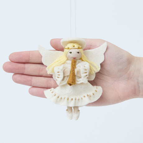 Craftspring’s Vintage-Style Angel Playing Trumpet Ornament displayed in front of a hand to show its size—handmade felt angel with intricate beaded and embroidered details, heirloom-quality Christmas ornament, perfect for holiday gifting, ethically crafted by artisans using sustainable wool.