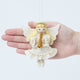 Craftspring’s Vintage-Style Angel Playing Trumpet Ornament displayed in front of a hand to show its size—handmade felt angel with intricate beaded and embroidered details, heirloom-quality Christmas ornament, perfect for holiday gifting, ethically crafted by artisans using sustainable wool.
