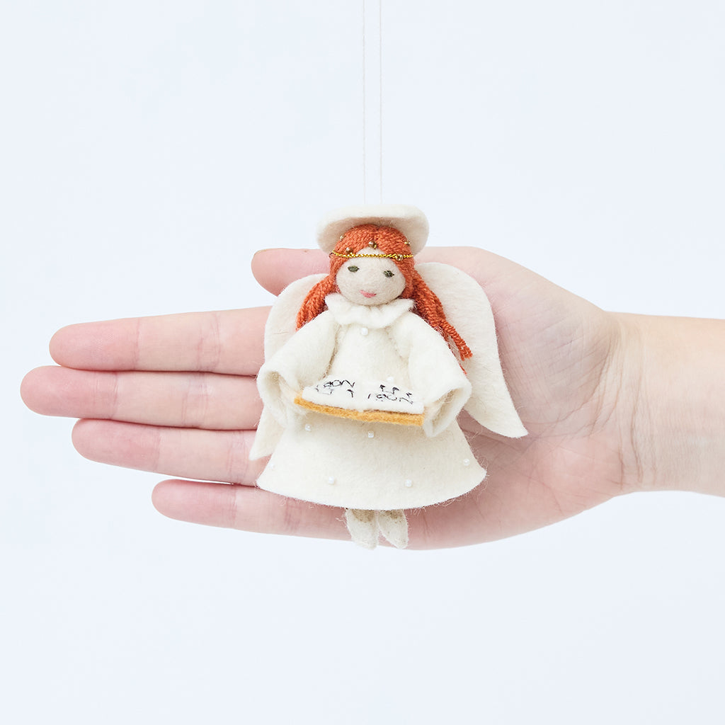 Craftspring’s Vintage-Style Angel Singing Noel Ornament displayed in front of a hand to show its size—handmade felt angel with intricate beaded and embroidered details, heirloom-quality Christmas ornament, perfect for holiday gifting, ethically crafted by artisans using sustainable wool.