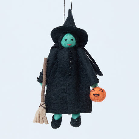 Handmade felt Wicked Witch Trick-or-Treater Ornament from Craftspring, with green skin, a witch’s hat, broom, and pumpkin basket—heirloom-quality Halloween decor, perfect for spooky decorating and holiday gifting, ethically crafted by artisans using sustainable wool.