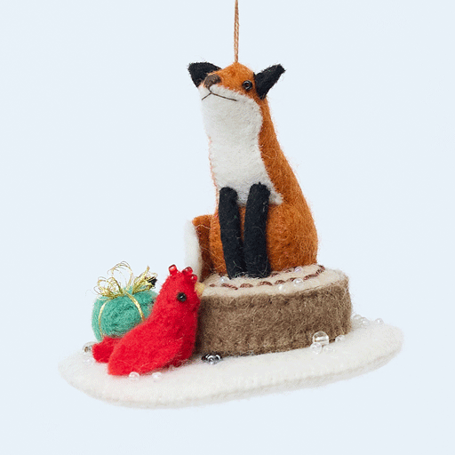 Handmade felt Fox on Stump Ornament from Craftspring rotating to show front, side, and back views—fox with green present and red cardinal, heirloom-quality Christmas decor, ethically crafted by artisans using sustainable wool.