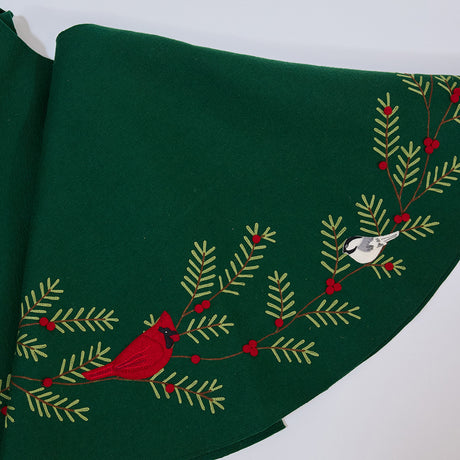 Craftspring’s Woodland Tree Skirt — handmade felt Christmas tree skirt with embroidered and appliqué pine branches and red berries, featuring woodland animals including a cardinal, squirrel, and chickadees — heirloom-quality holiday decor, ethically crafted by artisans using sustainable wool.