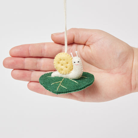 Cheerful felt snail with gentle smile and stitched shell – handmade from natural wool