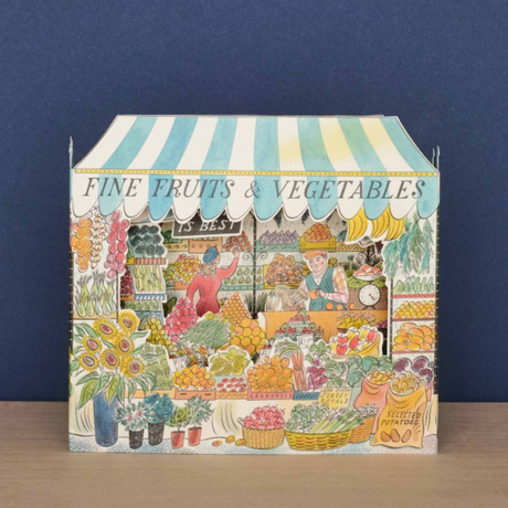 Celebrate the bounty and color of the farmer's market stall with this detailed and whimsical 3D card, illustrated by Emily Sutton. This beautiful die-cut design unfolds into a vibrant three-dimensional display of fresh produce. Peek in to discover a colorful world of painted fruits and veggies.&nbsp;