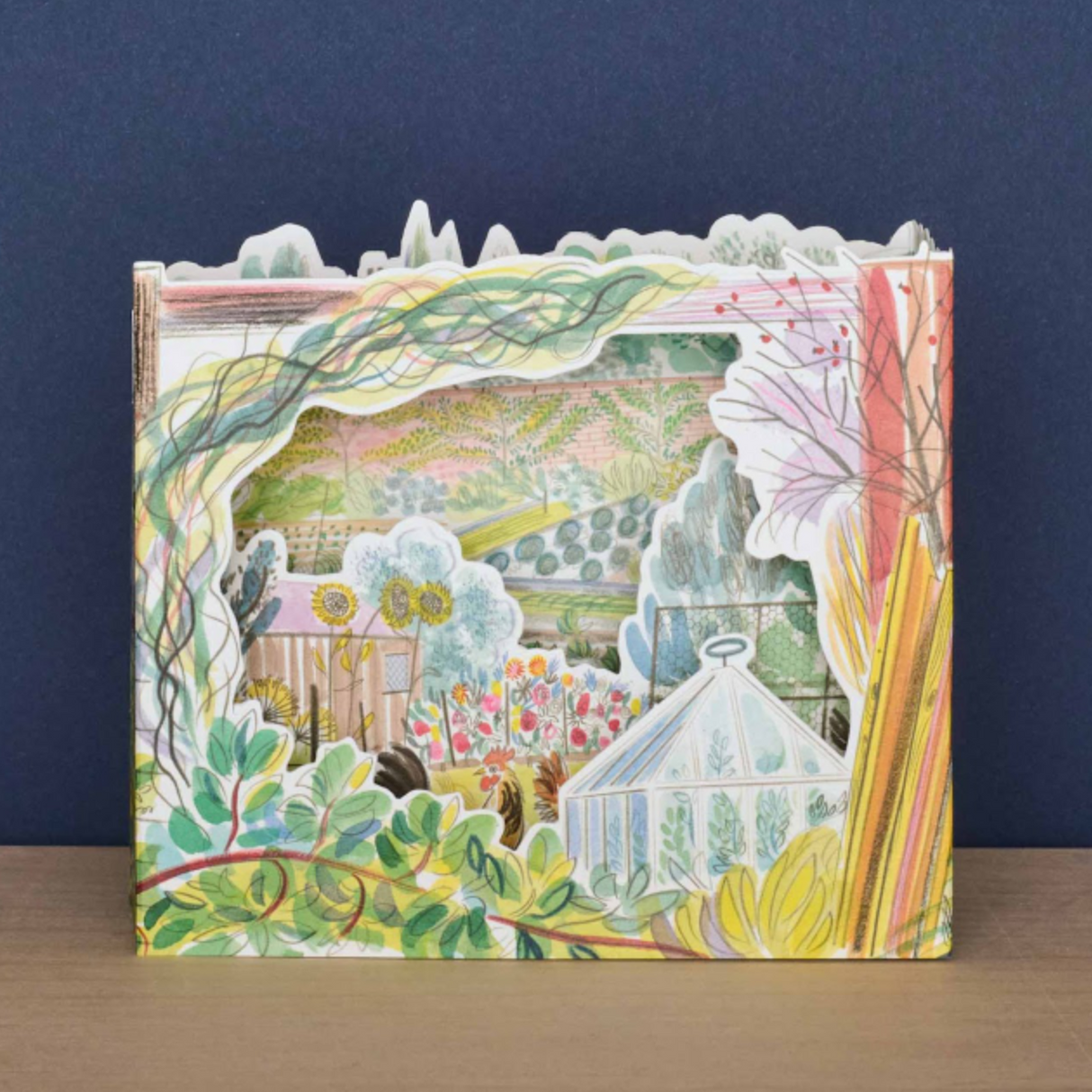 Step into the poetic beauty of the English countryside with this beautifully detailed 3D card, illustrated by celebrated British artist Emily Sutton. Inspired by the natural beauty and wildlife of Yorkshire, this piece captures the gentle charm of a sunlit garden in full bloom—rooted in the tradition of Victorian illustration and the romance of rural England.