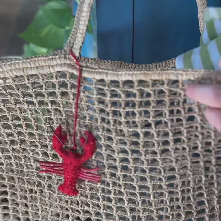 Effortlessly stylish and endlessly versatile, our Raffia Tote Bag is designed for beach days, market strolls, weekend getaways, and everyday adventures. Hand-crocheted from natural raffia fibers, this lightweight tote combines timeless coastal style with practical functionality, creating a beautiful accessory you'll reach for season after season.