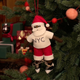 Celebrate Christmas in the Big Apple with our handmade NYC Santa Ornament, featuring a deep brown Santa dressed like a true New Yorker in an NYC tee and sneakers, with a classic slice of New York pizza in hand.