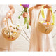 Strawberry-themed raffia basket for kids, handmade in Madagascar with sustainable materials.