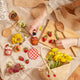 Lightweight raffia basket for kids with hand-stitched fruit, perfect for gathering or gifting.