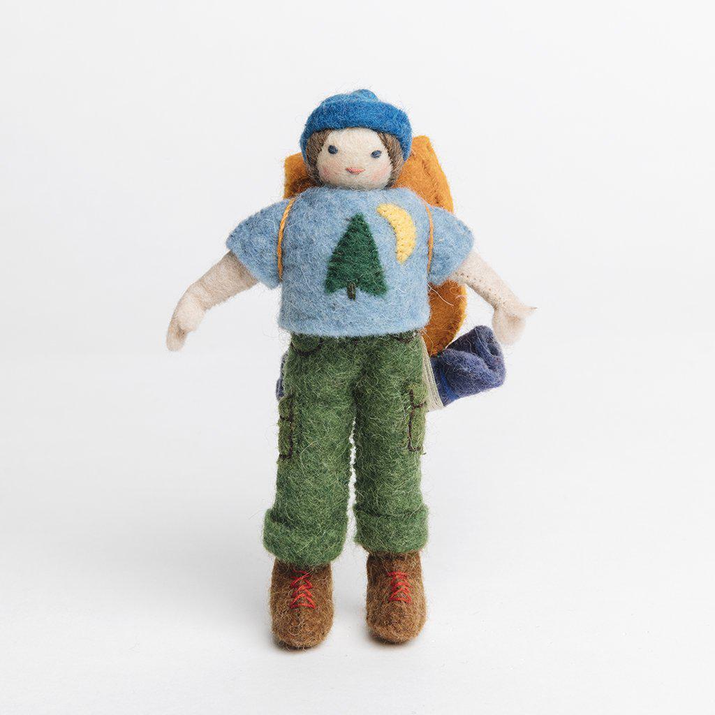 A handmade felt hiker ornament with light skin wearing brown hiking boots green cargo pants a blue shirt and cap with a brown backpack complete with bed roll. 