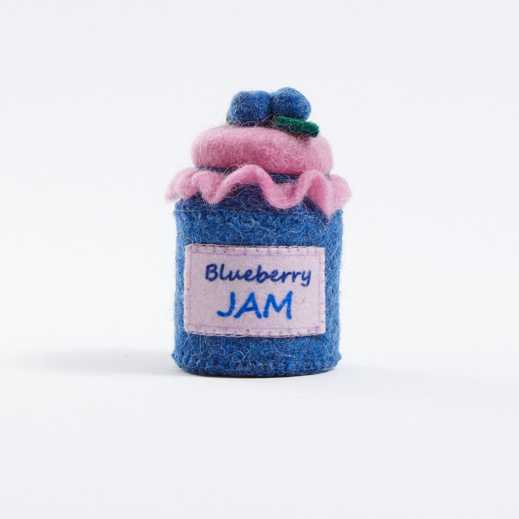 Felt blueberry jam ornament, part of Blueberry-themed felt ornament gift set in a kraft box with crinkle paper. Includes a felt blueberry jam jar, blueberry pint basket, and blueberry pancake stack. Handmade from wool felt using traditional needle-felting. Fair trade and ready to hang.