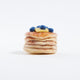 Felt pancake stack ornament topped with hand-felted blueberries and a yellow butter square. Handmade from natural wool felt using needle-felting. Fair trade and ready to hang.