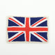 Felt British flag ornament featuring the embroidered Union Jack in red, white, and blue. Handmade from wool felt and cotton thread using traditional techniques. Fair trade and ready to hang.