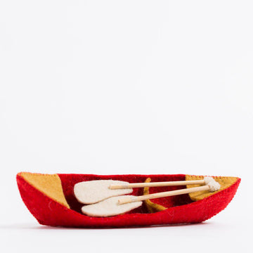 A Craftspring handmade red felt canoe ornament with two little paddles