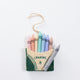 Felt pastel crayon box ornament with stitched details, handmade and fair trade.

