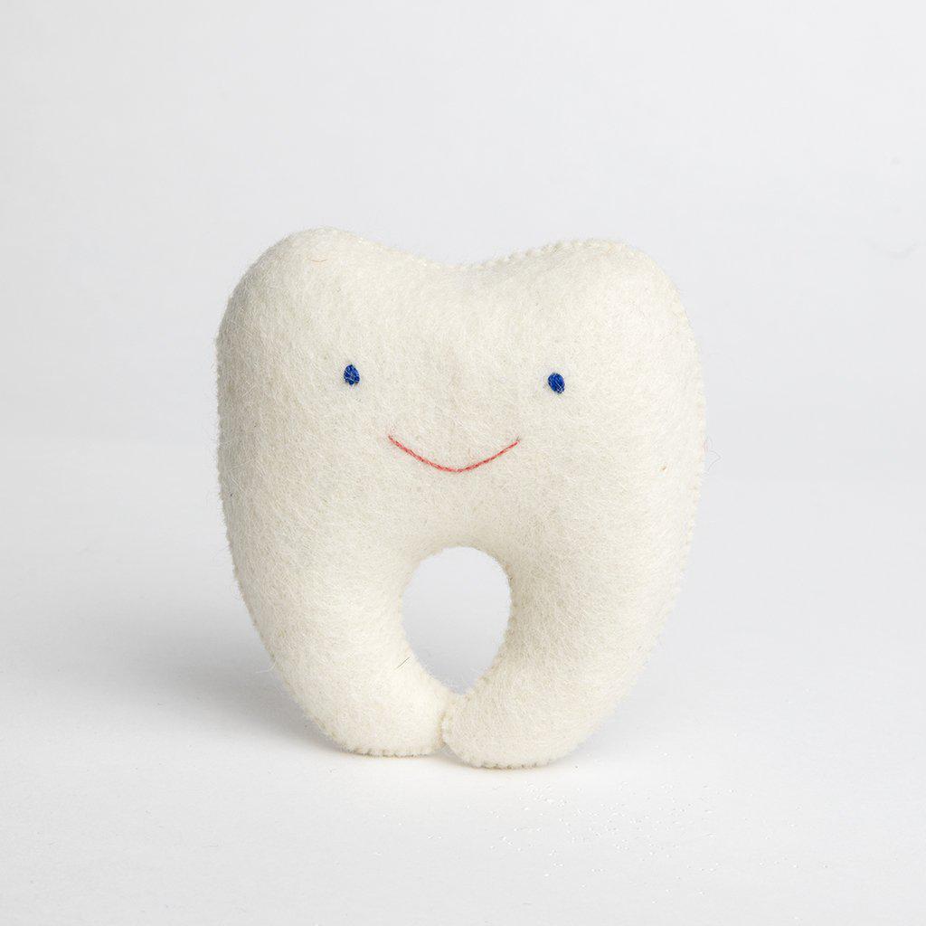 A Craftspring handmade felt tooth pillow with a small pocket on the back