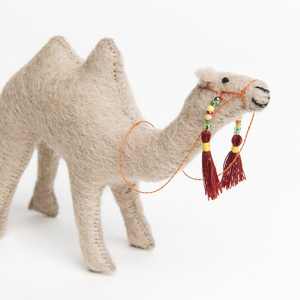 A Craftspring handmade felt camel ornament with a beaded bridal 