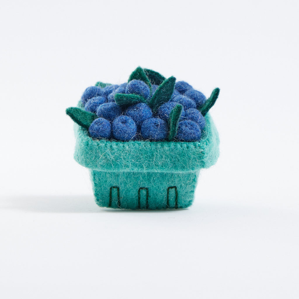 Felt blueberry pint ornament, part of Blueberry-themed felt ornament gift set in a kraft box with crinkle paper. Includes a felt blueberry jam jar, blueberry pint basket, and blueberry pancake stack. Handmade from wool felt using traditional needle-felting. Fair trade and ready to hang.