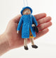 Queen Elizabeth II felt ornament wearing royal blue coat and hat, with black handbag and detailed embroidery. Handmade wool Christmas ornament honoring British royalty. Fair trade and ready to hang. Held in a hand for scale and size reference.