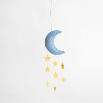 A Craftspring handmade blue felt crescent moon ornament with strings of yellow stars