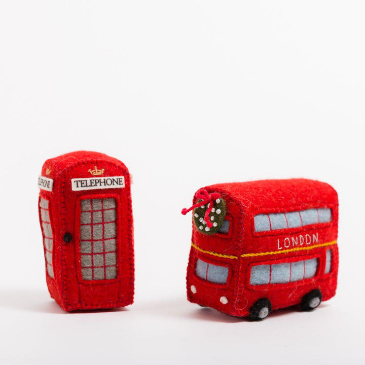 Felt ornament of a red London tour bus with holiday details, perfect for Christmas décor or travel-themed gifting. Handmade from wool felt. Fair trade and ready to hang.  Also a red British telephone box ornament