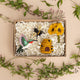 Handmade felt ornament gift box featuring pollinator-themed pieces in reusable packaging
