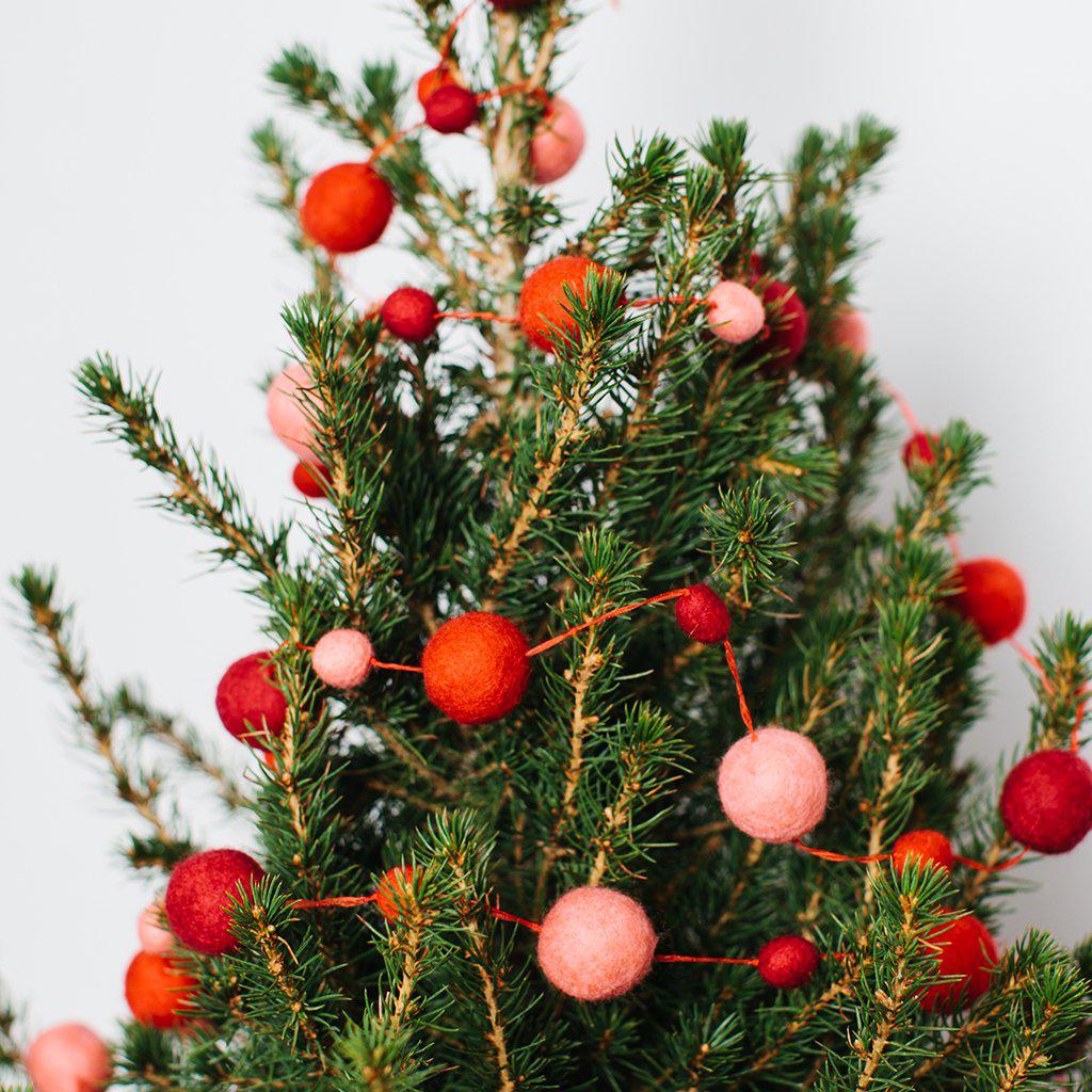 A craftspring handmade felt ball garland the felt balls in varying sizes in pink and red strung together with red string