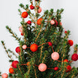 A craftspring handmade felt ball garland the felt balls in varying sizes in pink and red strung together with red string