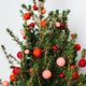 A craftspring handmade felt ball garland the felt balls in varying sizes in pink and red strung together with red string