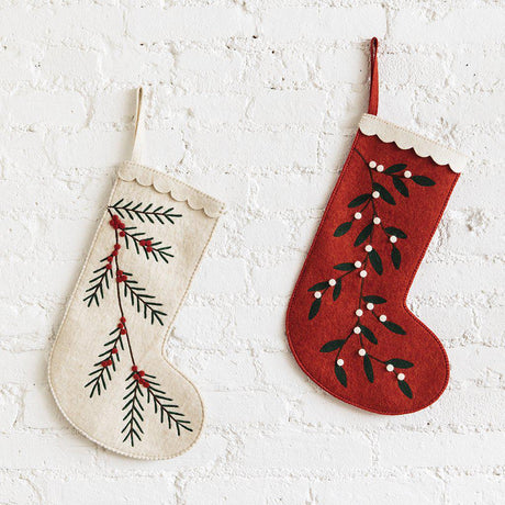 A Craftspring handmade red felt Christmas stocking with embroidered white berries and a white scalloped edge